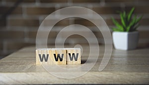 WWW word letter on wooden cubic with copy space. Internet website concept.