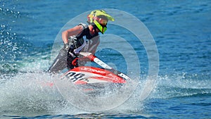 Close up of Jet Ski racer cornering at speed creating at lot of spray.