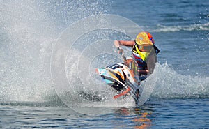 Jet Ski cornering at speed creating at lot of spray.