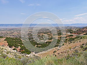 Wyoming landscape with a paved road snaking through the valley in Cody