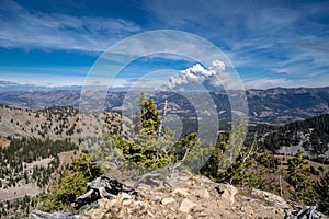 Wyoming mountain wildfire rages in the distance, view from a rid