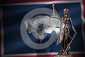 Wyoming US state flag with statue of lady justice and judicial scales in dark room. Concept of judgement and punishment