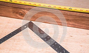 A 2x4 board measured and marked for cutting or nailing. photo