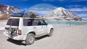 A 4x4 expedition vehicle in front of Laguna Verde and the Licancabur Volcano, Reserva Eduardo Avaroa, Sud Lipez province, Bolivia