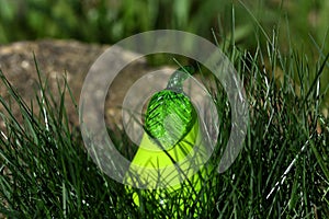 `Pear in the Bush` vivid neon green glass pear with grass and stone