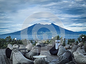 & x22;KOPI NAKO KEBON JATI& x22; Coffee Shop in Bogor West Java -Indonesia with a view of a Salak Mountain in front of it photo