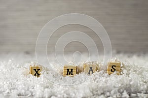 X mas word made of letters on wooden cubes on a snow background 4