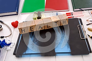 X-ray with pills and notepads on table