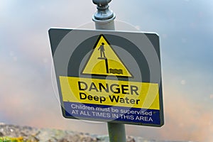 A "Danger Deep Water" phrase on a sign