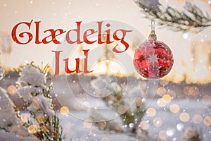 "GlÃ¦delig Jul" means "Merry Christmas" in Danish. Blurred background of Christmas tree branch under snow
