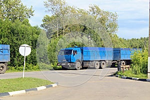 The & x22;Kamaz& x22; truck of blue color with a trailer is moving along,