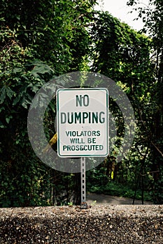 "No Dumping" warning sign, violators will be prosecuted
