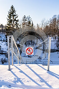 "No entry", "Do not enter" Sign in a Park in Metal Chains on a Sunny Winter Day