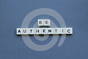 ' Be Authentic ' word made of square letter word on grey background