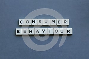 ' Consumer Behaviour ' word made of square letter word on grey background