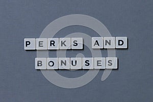 ' Perks And Bonuses ' word made of square letter word on grey background