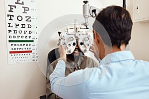 It's always worth seeing an optometrist. Shot of an optometrist examining her patients eyes with an optical