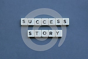 ' Success Story ' word made of square letter word on grey background