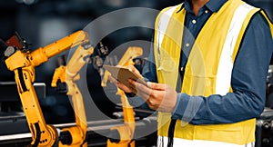 XAI Engineer use advanced robotic software to control industry robot arm in factory