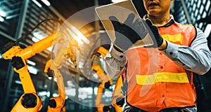 XAI Engineer use advanced robotic software to control industry robot arm in factory