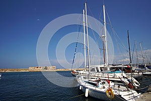 Xania, Crete, Greece October 01 2018 Panoramic view of the Venetian harbor with its ancient lighthouse and sailing vessels photo