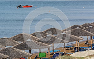 Xi beach parasol speedboat in the backgroend, Kefalonia Greece