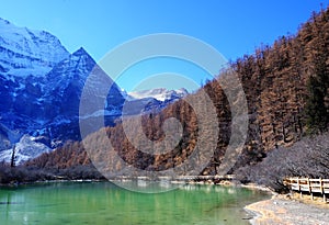 Xiannairi mountain in a lush landscape in front of a tranquil lake