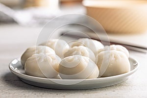 Xiao long bao. Chinese dumplings on plate on kitchen table