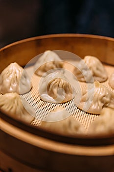 Xiao Long Bao Chinese Soup Dumpling with minced pork inside in bamboo streamer