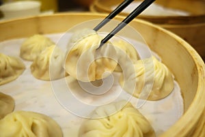 Xiao Long Bao with chopsticks Streamed Pork Dumplings Taiwan foo