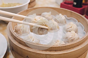 Xiao long bao soup dumpling buns with chopsticks in restaurant Traditional Chinese food in Taipei Taiwan