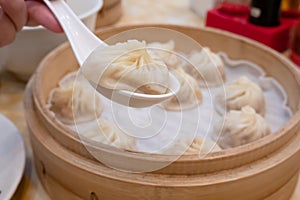 Xiao long bao soup dumpling buns with chopsticks in restaurant Traditional Chinese food in Taipei Taiwan