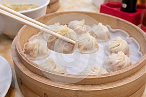 Xiao long bao soup dumpling buns with chopsticks in restaurant Traditional Chinese food in Taipei Taiwan