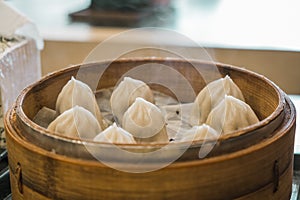 Xiao Long Pao in small bamboo steaming basket.