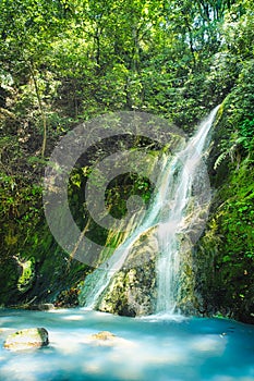 Xiao Yintang Waterfall of Yangmingshan National Park with milky cold spring and sunlight on sunny day, shot in Taipei, Taiwan.