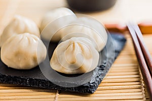 Xiaolongbao, traditional steamed dumplings. Xiao Long Bao buns on cutting board
