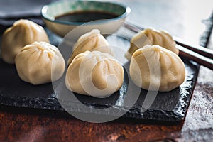 Xiaolongbao, traditional steamed dumplings. Xiao Long Bao buns on cutting board