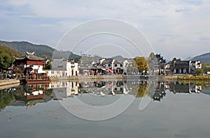 Xidi Ancient Town in Anhui Province, China. The old town and Hu Wenguang memorial archway seen across Ming Jing Lake