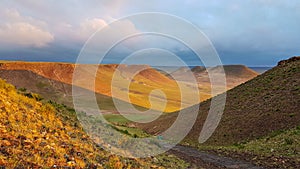 Xilinhot - A colofrul sunrise seen from a small hill in the suburbs of Xilinhot, Inner Mongolia. The sun paints the hills orange photo