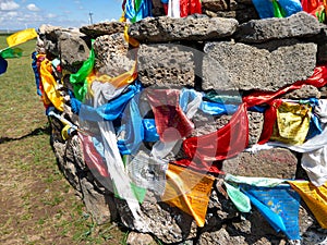 Xilinhot - Heaps of stones (Aobao) build on a vast pasture in Xilinhot in Inner Mongolia. The Heaps has colorful prayer flags