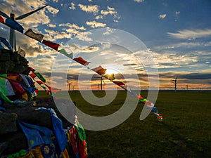 Xilinhot - Heaps of stones Aobao build on a vast pasture in Xilinhot in Inner Mongolia. The Heaps has colorful prayer flags
