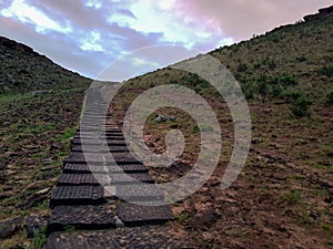 Xilinhot - A staircase leading to the top of a small hill in the suburbs of Inner Mongolia. The hills are overgrown with grass