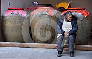 Xin Xing Zhen, China: Woman with Pottery Urns