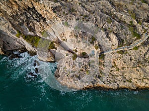 Xlendi cliff steps towards Caroline Cave aerial Gozo Malta