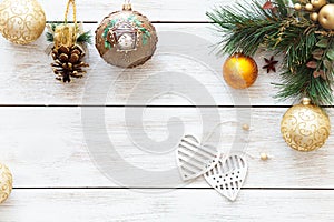 Xmas balls hearts on Christmas tree, happy new year card decoration on white wooden background, top view, copy space