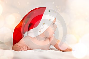 Xmas card with cute baby girl with santa hat on beige airy briht background with copy space