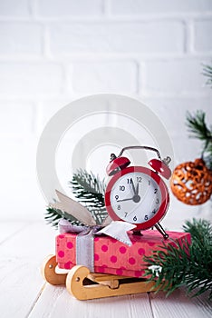 Xmas greeting card. Christmas background with snow fir tree and alarm clock. View from above with space for your