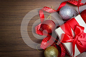 Xmas holiday celebration. New Year 2020. white gift box tied in a red ribbon bow placed. Christmas ball. on a wooden background