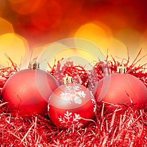 Xmas red balls on blurred red yellow background