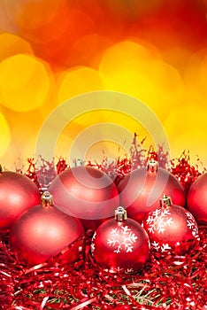 Xmas red bauble on blurred red yellow background